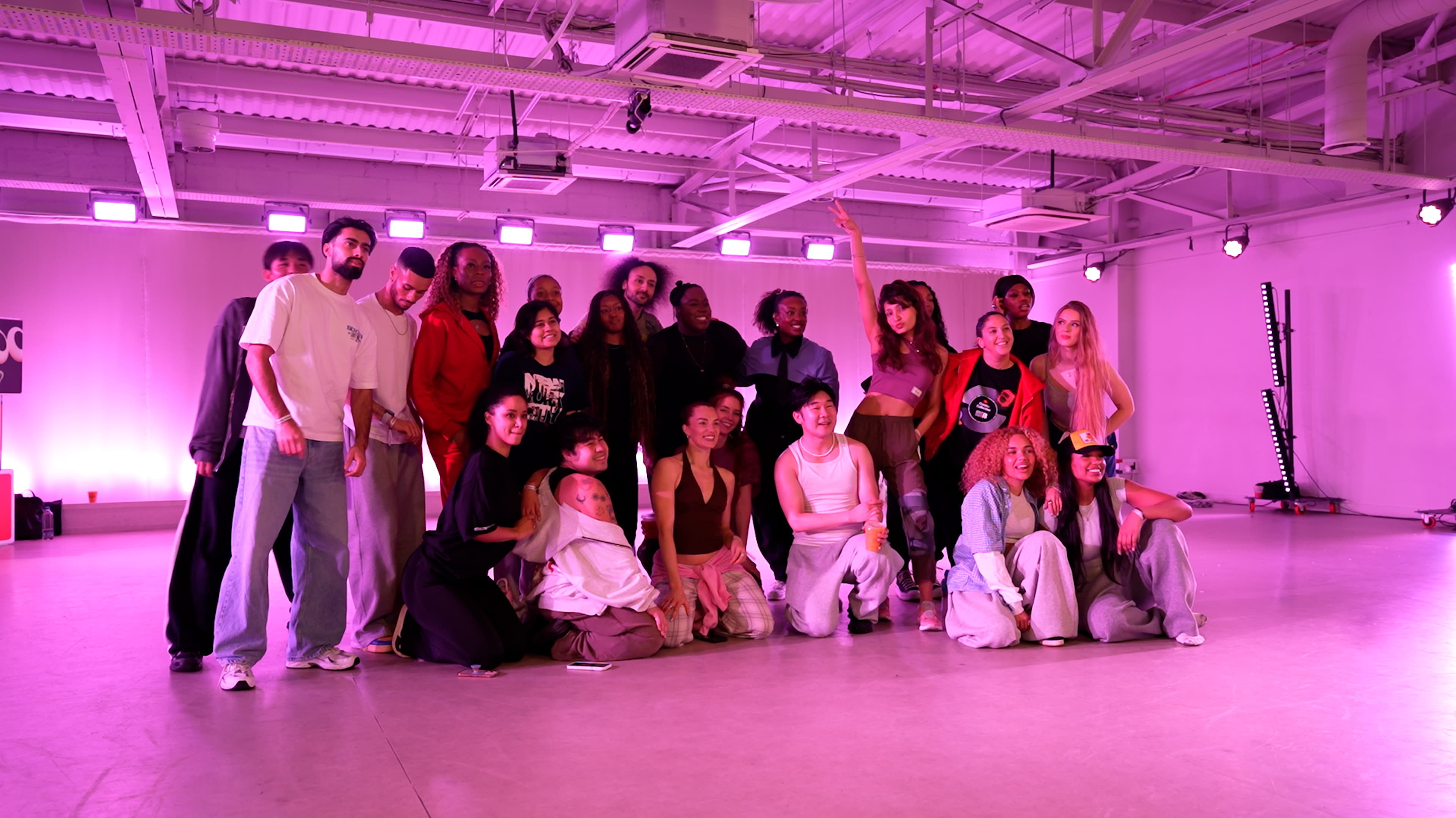 YouTube Creator Collective event at The Manor LDN, with creators taking part in a branded dance workshop and social experience under vibrant pink and purple lighting, alongside group moments and YouTube-branded event details.