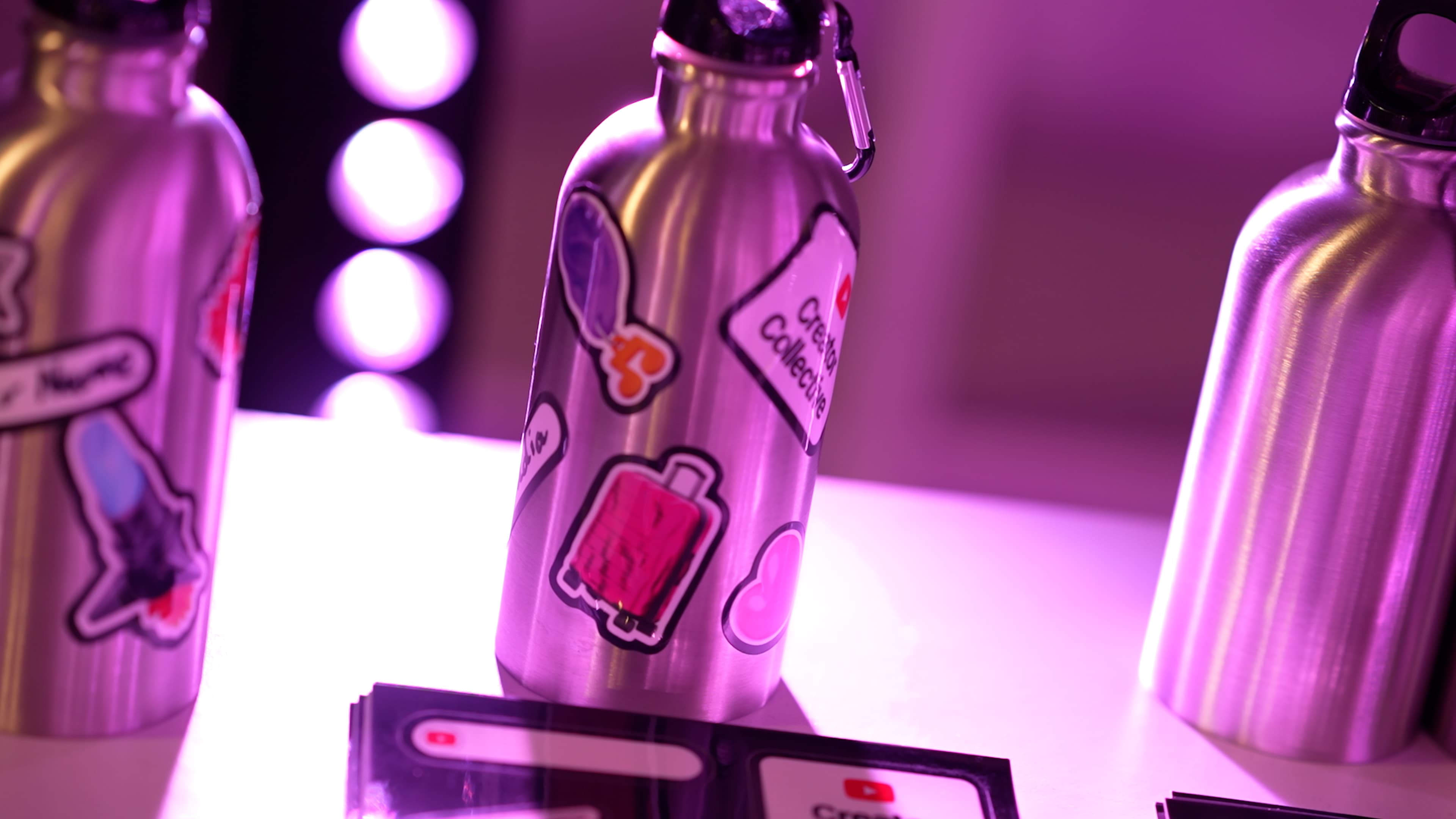 YouTube Creator Collective event at The Manor LDN, with creators taking part in a branded dance workshop and social experience under vibrant pink and purple lighting, alongside group moments and YouTube-branded event details.